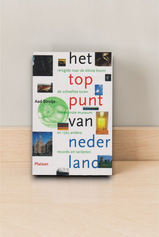 Boek "Het toppunt van Nederland" staand op een houten ondergrond.