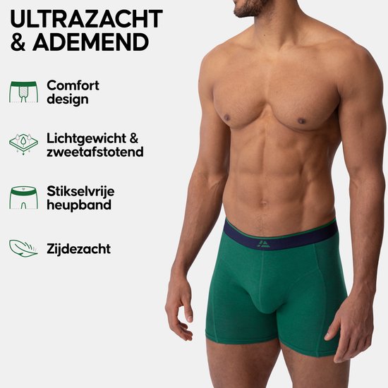 Model draagt een groene boxershort met donkerblauwe tailleband. Tekst: Ultrazacht & ademend met voordelen op een rij.