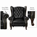 Zwarte leren wingback fauteuil met dikke armleuningen, capitons, goudkleurige klinknagels en bolpoten.