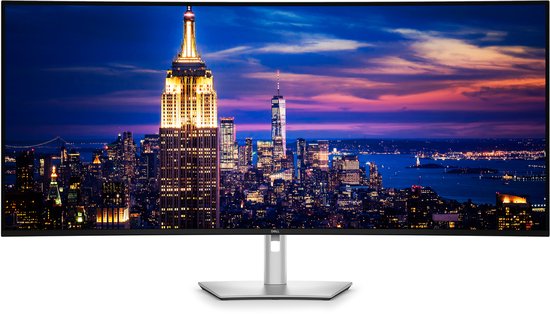 Een gebogen Dell monitor toont de Empire State Building bij nacht.