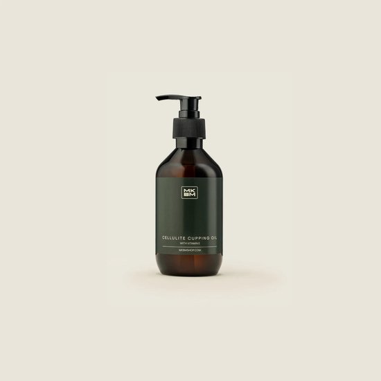 Bruine fles met pompdispenser en groen etiket met 'MKBM CELLULITE CUPPING OIL WITH VITAMIN E'.