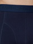 Detail van een marineblauwe boxslip met 'MUCHACHOMALO' logo-band en stiksels.