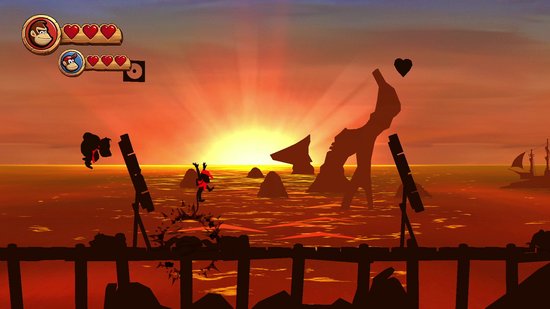 Donkey Kong et Diddy Kong sautent sur un soleil couchant au-dessus de l'océan.