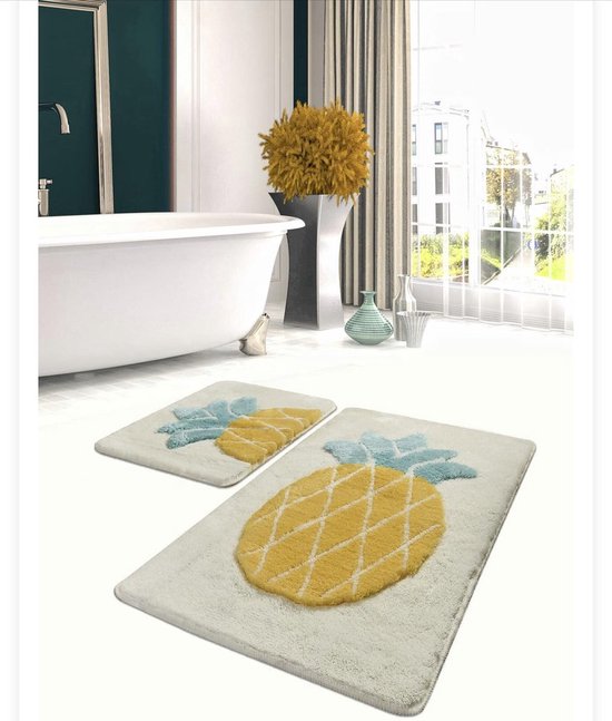 Set van twee witte badmatten met een gele ananasprint en blauwe bladeren.