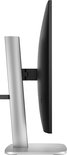 Zijaanzicht van een zwarte monitor met een zilveren, stevige standaard.