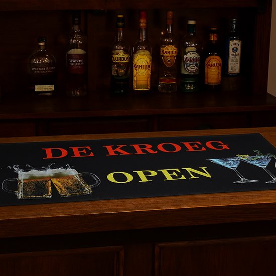 Zwarte barmat met rode tekst 'DE KROEG' en gele tekst 'OPEN', met glazen bier en martiniglazen.