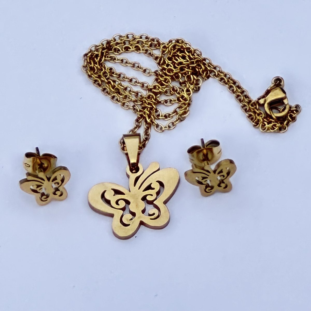 GoedeDoelen.Shop | RVS Ketting Oorbel-set Butterfly Gold | Goudkleurige Sieraden Set | Kettinglengte 45 CM | Vlinder Sieraad | Gedenk Sieraad | Cancer Awareness | Transformatie | Vlinder Oorbellen | Vlinder Ketting | Wellness-House