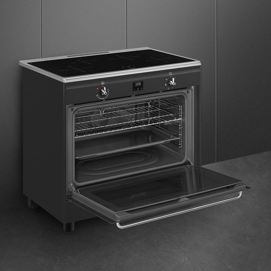 Zwart inductiefornuis met open ovendeur, vier kookzones en digitale klok.