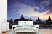 Behang - Fotobehang Paarse ochtendlucht boven de Borobudur - Breedte 420 cm x hoogte 280 cm