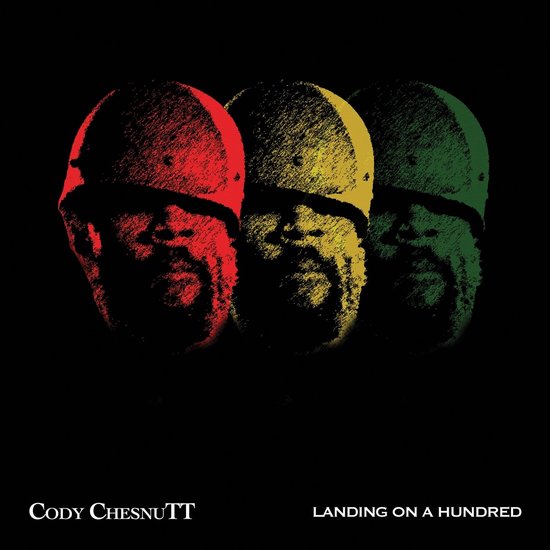 Albumhoes met de titel "Landing On A Hundred" en artiest "Cody Chesnutt". Drie overlappende portretten in rood, geel en groen.