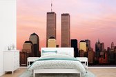 Behang - Fotobehang De twee wolkenkrabbers van het World Trade Center onder een roze lucht in New York - Breedte 420 cm x hoogte 280 cm