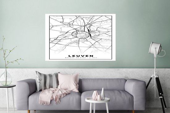 Affiche avec une carte en noir et blanc de Leuven, Belgique, avec un motif de rues et le texte LEUVEN, accrochée au-dessus d'un canapé gris.