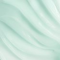 Abstracte textuur van een lichtgroene crème met golvende lijnen.