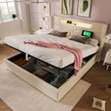 Lit rembourré beige avec espace de rangement relevable. Éclairage LED et ports USB dans la tête de lit.