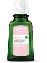 Groene fles Weleda Sensitive Herstellende Gezichtsolie met een roze label en witte dop. "100% NATURAE" logo.