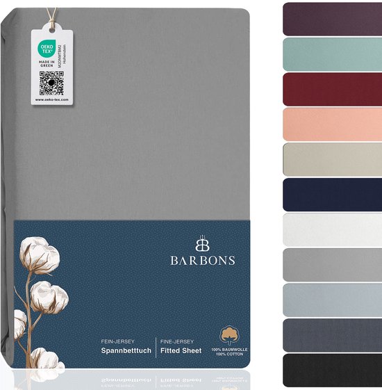Un drap-housse en jersey gris clair emballé dans une housse bleu foncé avec une image de coton et un label Oeko-Tex.