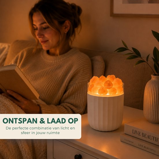 Een vrouw leest een boek naast een brandende Boncy zoutsteen lamp met een warme gloed.
