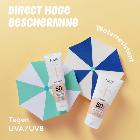 Twee tubes Naïf Baby & Kids zonnebrandcrème SPF 50 op een openklapbare strandparasol.