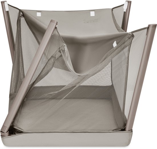 Opgevouwen grijs reisbedje met metalen frame en gaas.