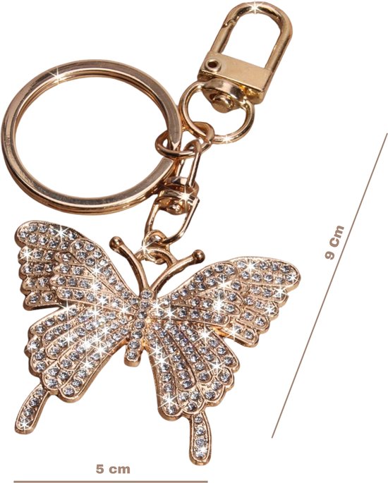 Gouden sleutelhanger met strass vlinderhanger. Afmetingen: 5 cm breed, 9 cm hoog.