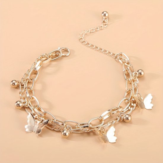 Gouden armband met twee lagen schakels, versierd met vlinders en balletjes.