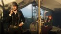 Man met hoed en sigaren rookt in een tent, naast een vrouw die kaarten vasthoudt.