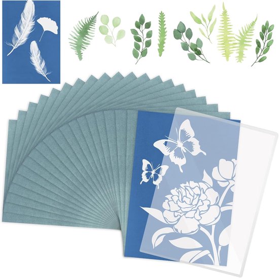 Papier en stencils met witte veren, bladeren en vlinders op blauw papier.