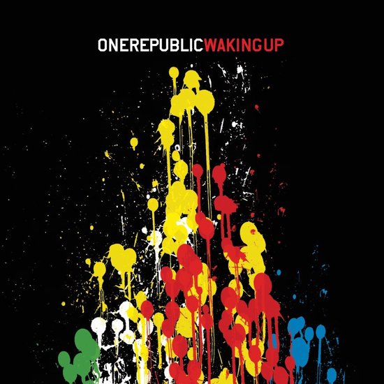 Albumhoes met de tekst ONEREPUBLIC WAKING UP, boven een explosie van rode, gele, groene en blauwe verfspatten op een zwarte achtergrond.