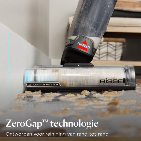 BISSELL CrossWave met ZeroGap technologie reinigt vuil langs de randen van een muur.