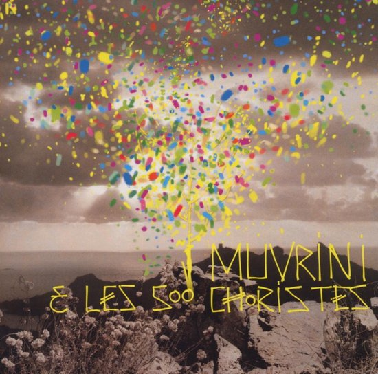 Albumhoes met kleurrijke confetti-explosie boven rotsachtig landschap met zee. Tekst: I Muvrini & Les 500 Choristes.