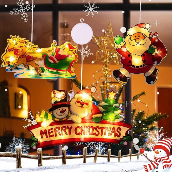 Verlichte kerstdecoraties met kerstman, rendierslee en "Merry Christmas" banner.