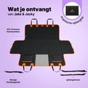 Couverture pour chien noire dépliée avec bordure orange, incluant une ceinture pour chien et des sangles de suspension. Sac de rangement Jake & Jacky montré.