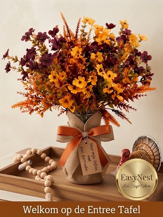 Bouquet de fleurs artificielles aux tons d'automne avec un nœud orange et une étiquette 'Pour ma chère, avec salutations'.