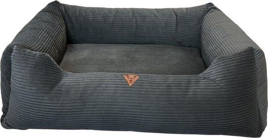 Donkergrijs corduroy hondenbed met stevige, zachte randen en een comfortabel ligkussen. Merklogo op de zijkant.