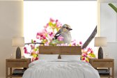 Behang - Fotobehang Vogel tussen roze bloemen - Breedte 350 cm x hoogte 350 cm