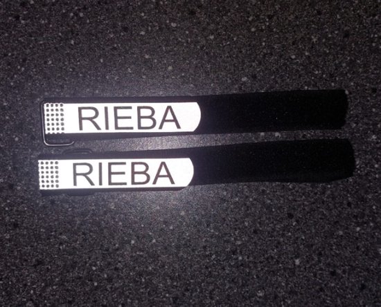 Twee zwarte broekklemmen met klittenband en een reflecterend 'RIEBA' logo.