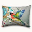 Een kussen met een levendige vogel op een tak, bloemen en mandala-patronen in blauw, groen, oranje en rood.