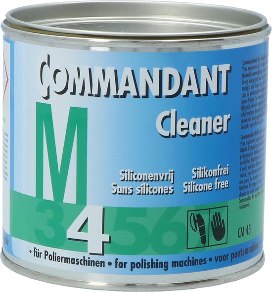 Commandant M Cleaner blik met informatie in meerdere talen en waarschuwingssymbolen.