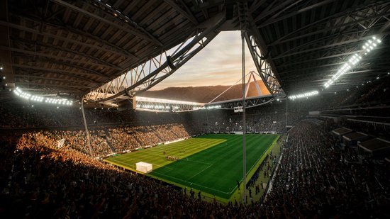 Avondopname van een vol voetbalstadion met een zonsondergang boven de bergen.