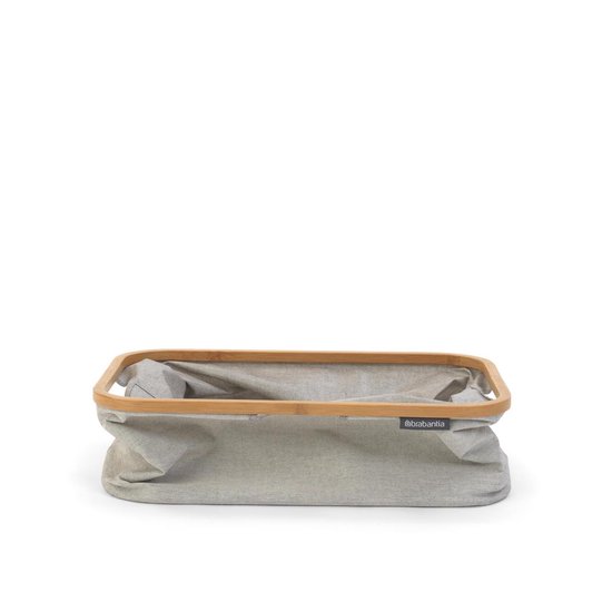 Grijze Brabantia wasmand met bamboe frame, opgevouwen.