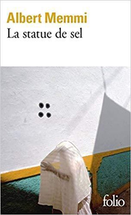 Boek kaft met de titel "La statue de sel" door Albert Memmi, tegen een witte muur met een gele en groene rand.