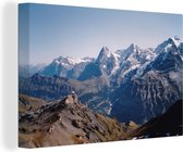 Canvas Schilderij Uitzicht op de Berner Alpen vanaf de top van de Schilthorn in Zwitserland - 90x60 cm - Wanddecoratie