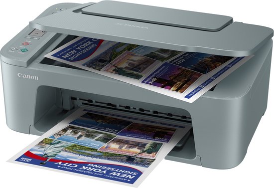 Grijze Canon Pixma printer print documenten met afbeeldingen van New York City, waaronder het Vrijheidsbeeld.
