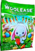 Groene verpakking met "My Woolease" en "Haak Je Eigen Konijn" in witte letters. Een gehaakte witte konijn met roze oren en een wortel.
