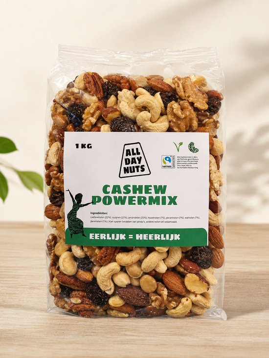 1 KG zak "ALL DAY NUTS CASHEW POWERMIX" met ingrediënten zoals cashewnoten, rozijnen, amandelen, pecannoten en walnoten.