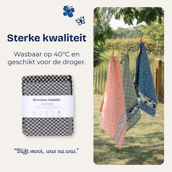 Trois torchons dehors sur une corde à linge, avec le texte 'Qualité solide'.