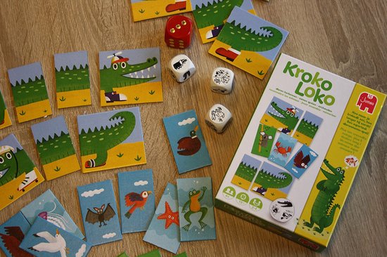 Jeu avec des cartes de crocodiles et d'autres animaux, des dés et une boîte de jeu 'Kroko Loko'.