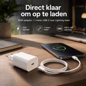 Witte 20W adapter en een witte 1 meter USB-C naar Lightning kabel op een houten bureau.
