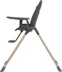 Chaise haute Maxi-Cosi gris foncé de profil avec pieds beiges.