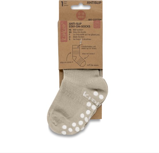Beige KipKep Stay-On antislip sok in verpakking met de tekst 'BIO-COTTON' en '12-18 MND'.